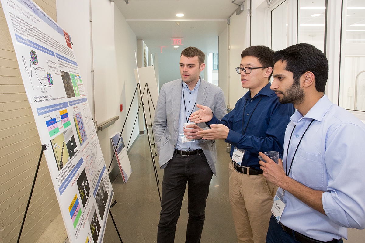 students discuss research during poster session
