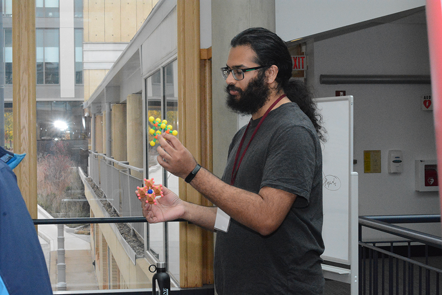 Grad student explaining a concept with molecule models