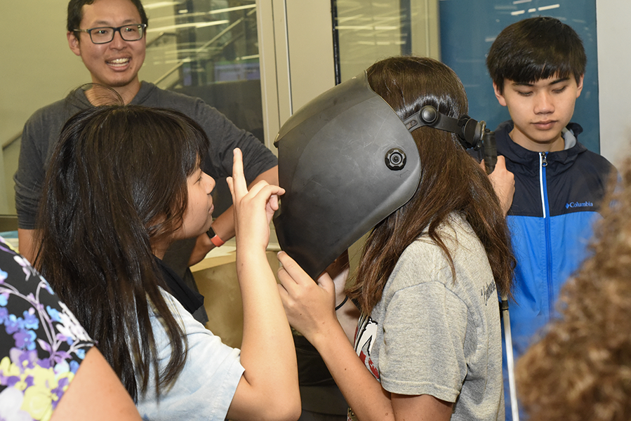 Students try on equipment in Tech Spark