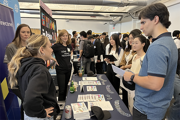 Students talking to a recruiter at CMU-SV Converge