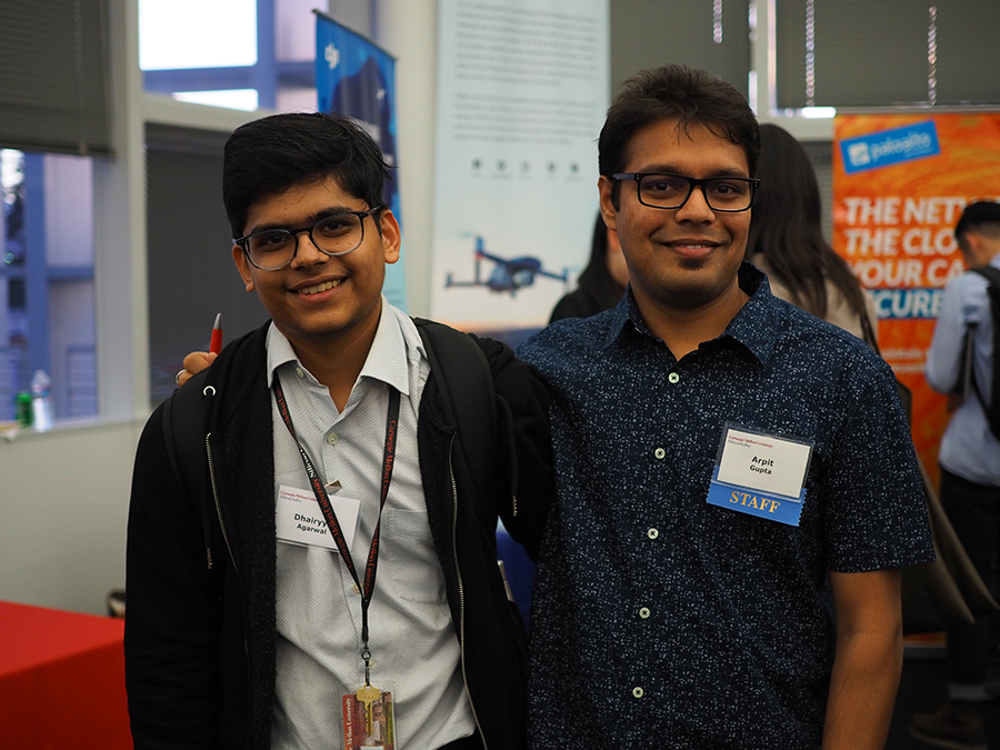 Two students at the 2019 event, with one student's arm over the other