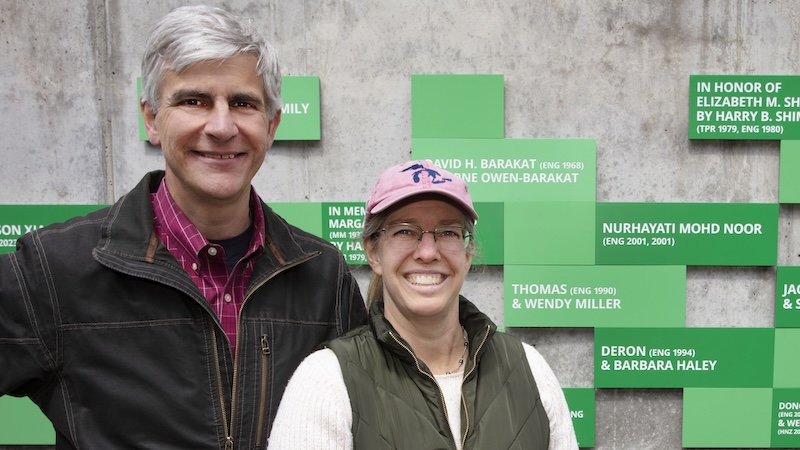 A man with his arm around his wife in front of the FOEB