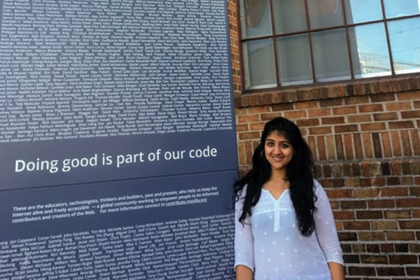 Simran Gujral in front of Mozilla sign