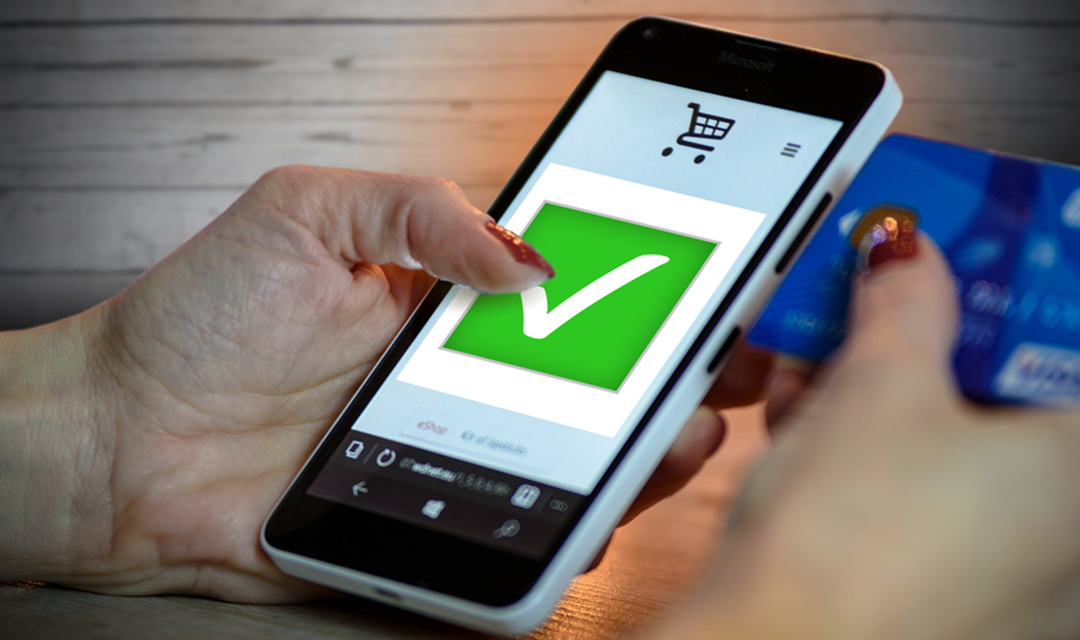 Woman using smartphone to purchase something
