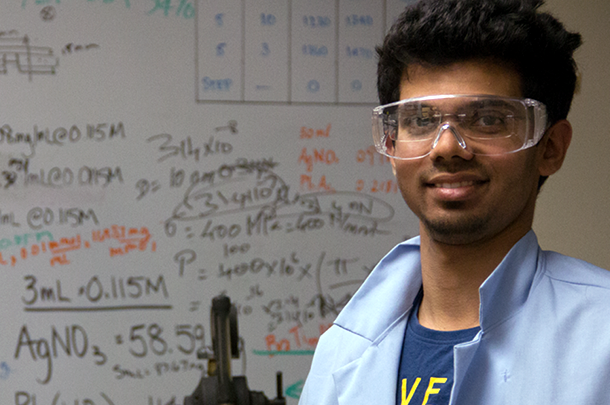 Ajay Pisat in safety glasses in front of white board