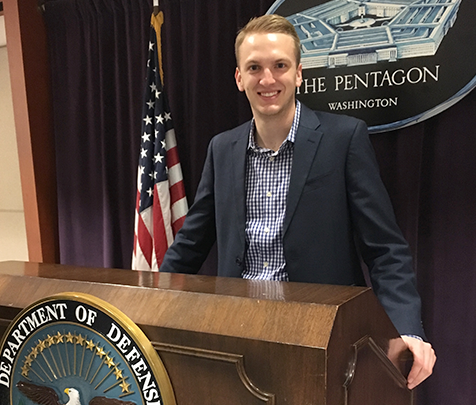 Tyler Kohman behind podium at the Pentagon