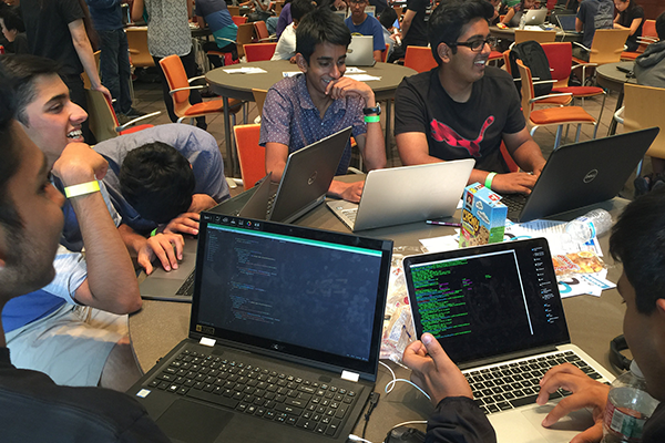 Students work on laptops at hackathon