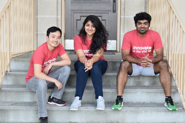 3 INI students sitting on steps