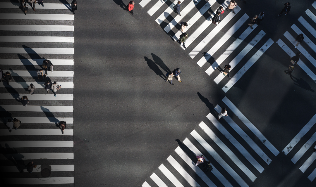 People walking through intersections in a city