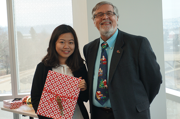 Landis standing with someone holding a present