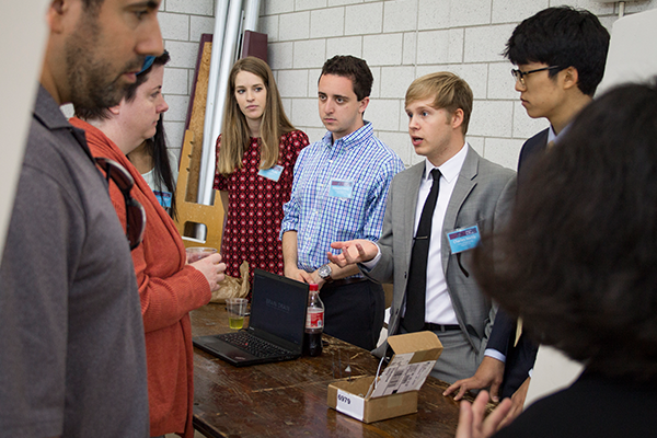 Students talking beside research poster