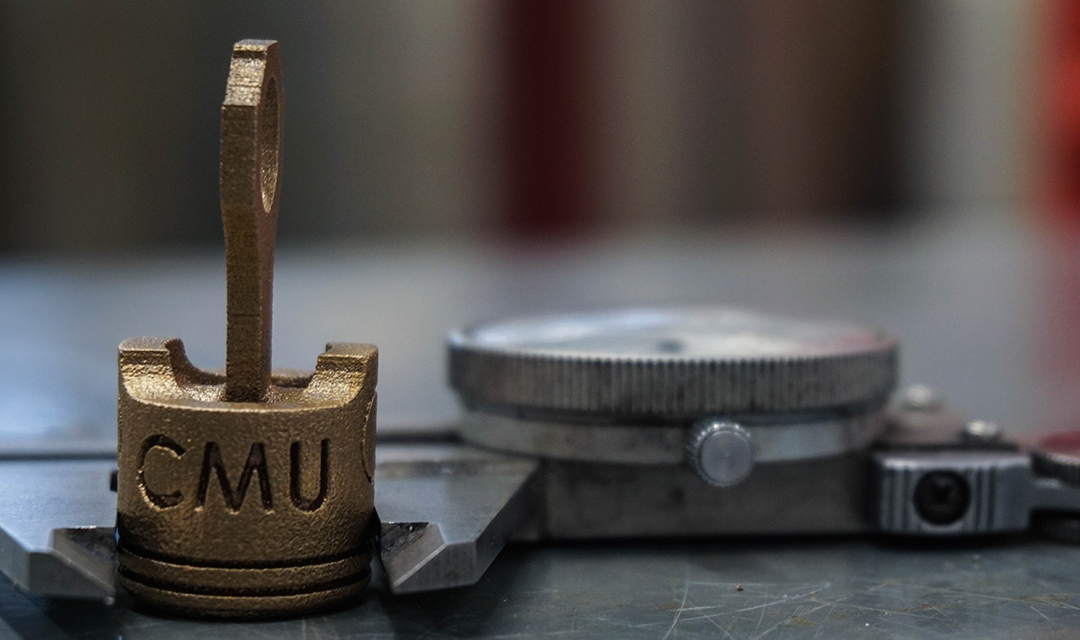 3-D printed structure that reads "CMU"