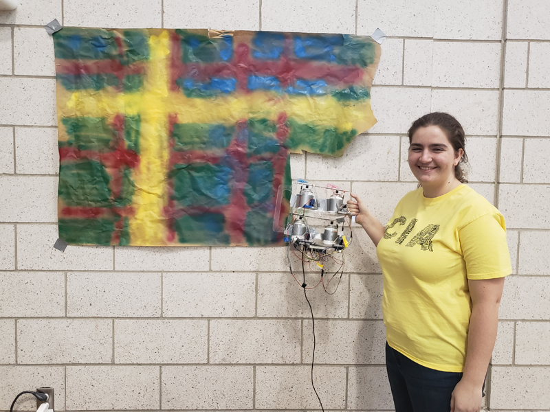 MechE, Engineering & Public Policy, Computer Science, and Chemistry sophomores, inspired by CMU's "tartan" school color, designed a robot that could follow a digital pattern that translated to physical spray cans taking turns to achieve the tartan look.
