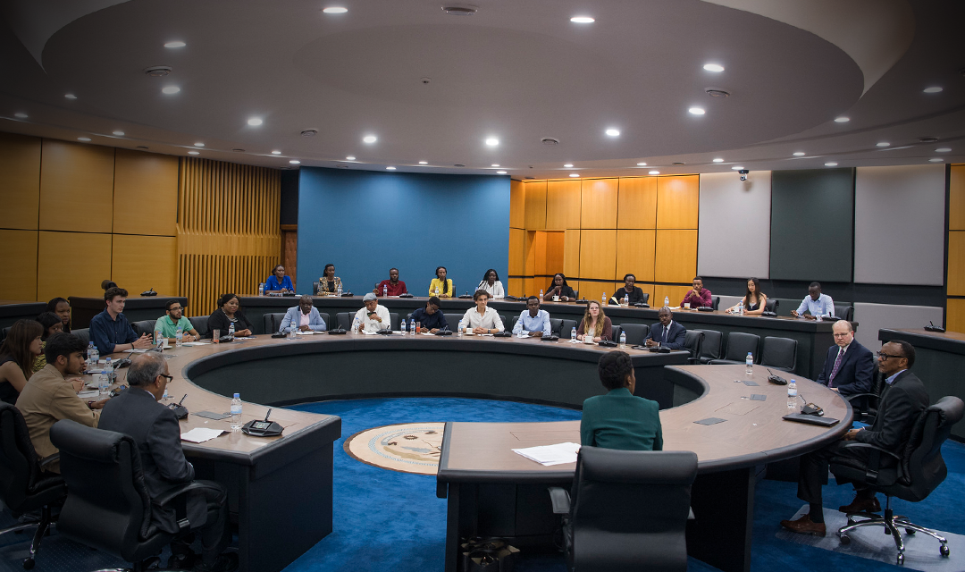 President Kagame, students, and representatives from CMU-Africa sitting at a round conference table.
