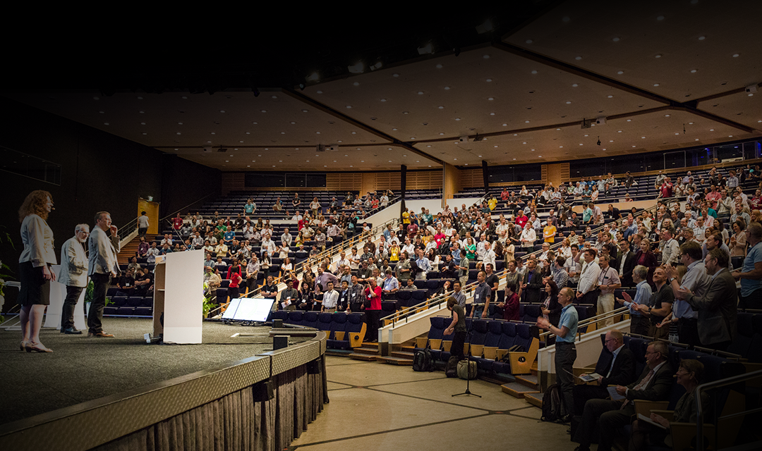Full auditorium with Peraire receiving a standing ovation