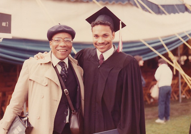 Two men standing in front of a tent.