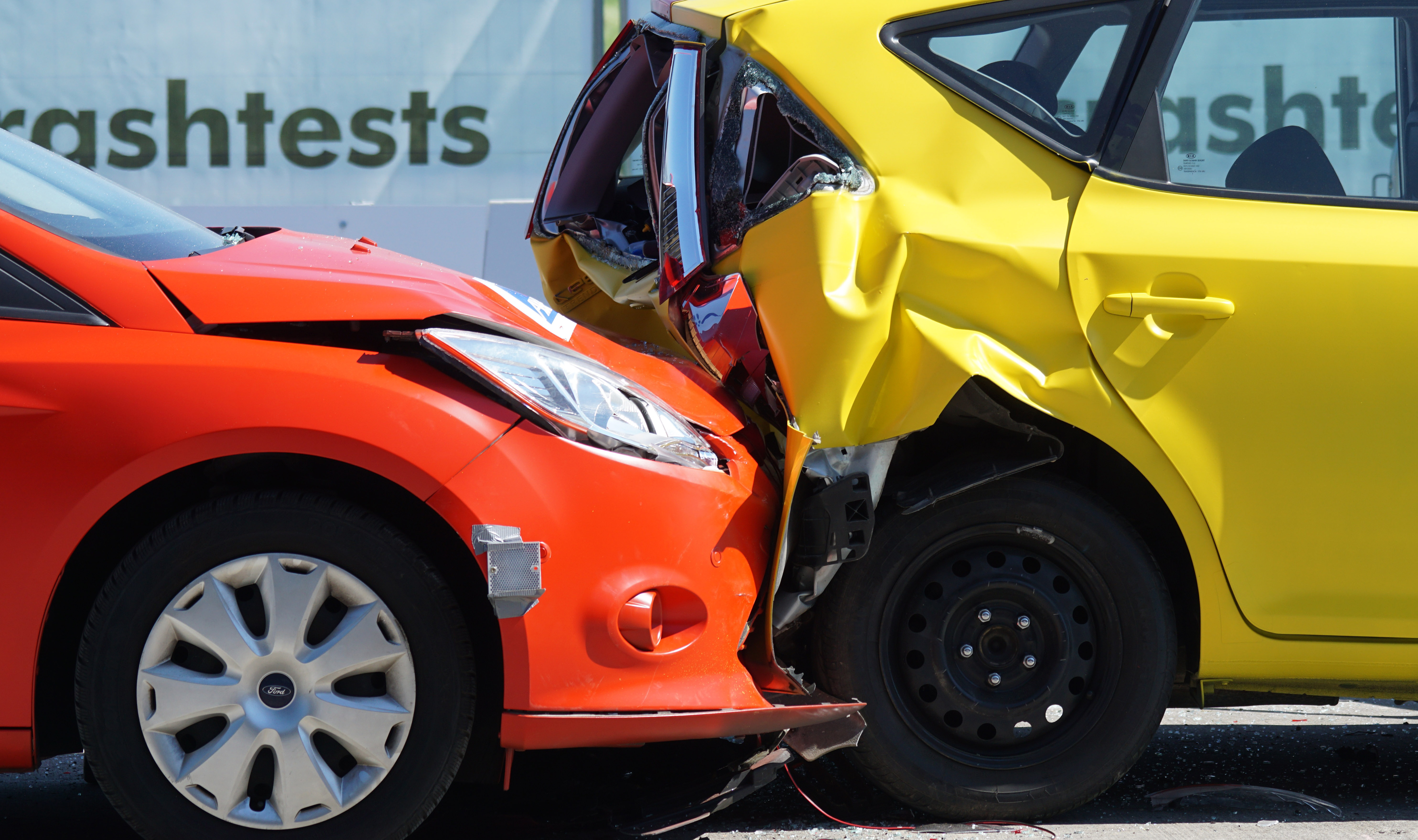 A car crash showing the front of one car crashed into the back of another