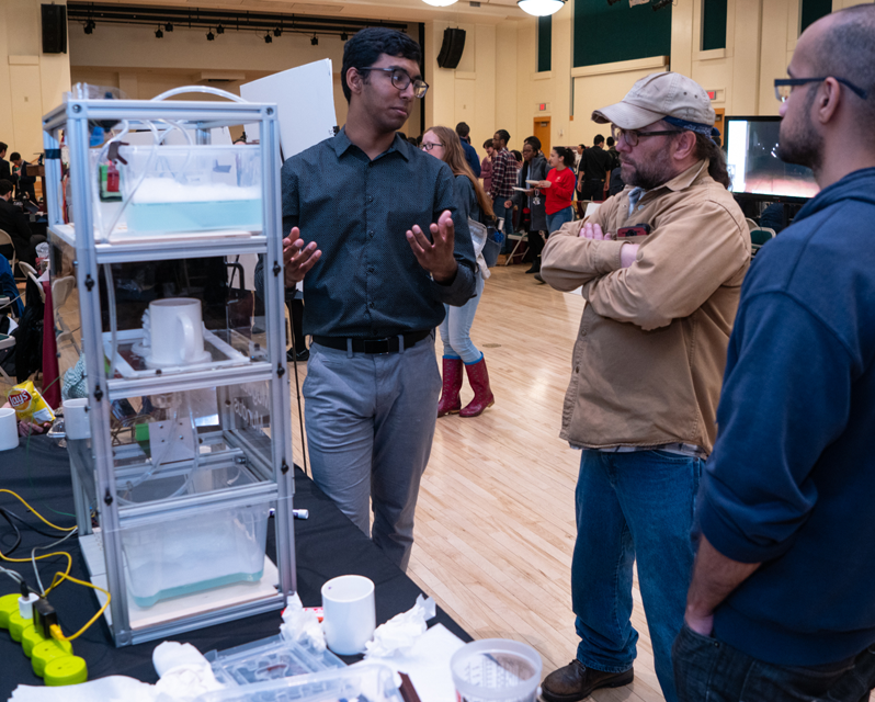 Student speaking to two visitors