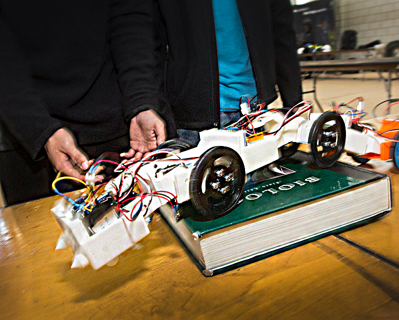 A robot maneuvering over a book