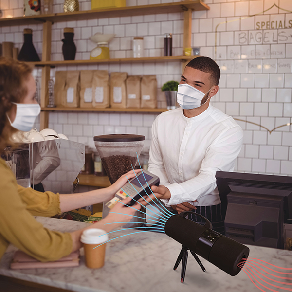 A woman interacting with a cashier in a coffee shop, with an active air stream separating them