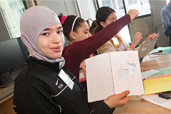 Young woman holding up her project