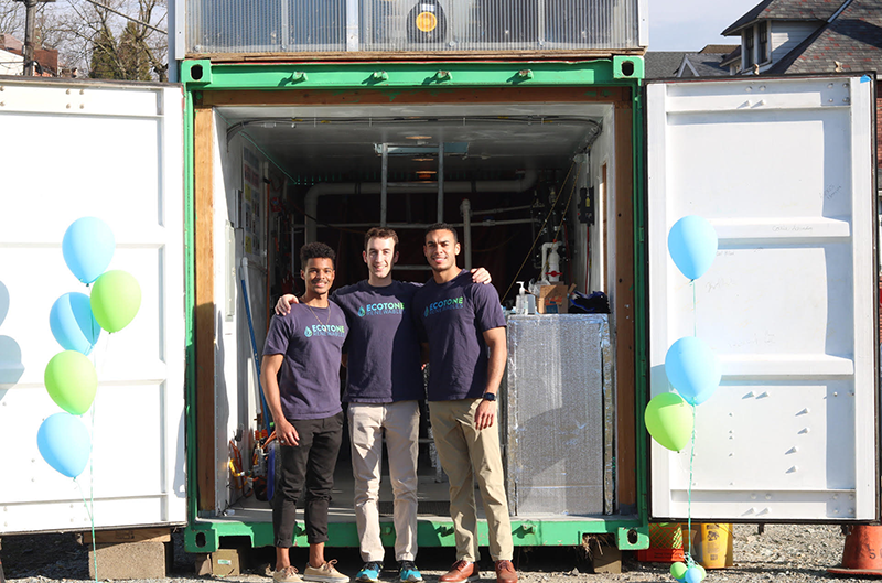 Three young adults outside the business