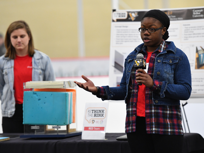 Two students around their project