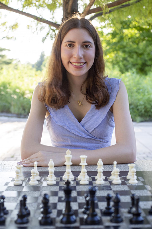 Student in a park with her chess board