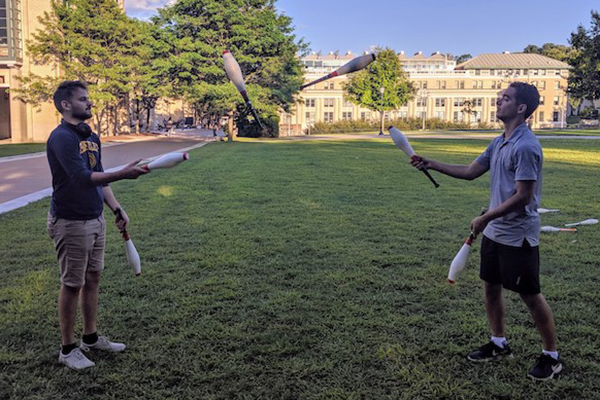 Two students juggling