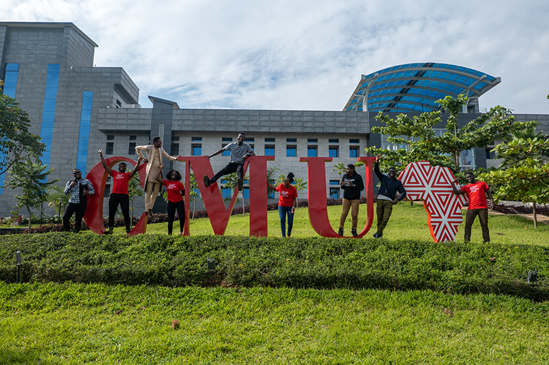 Students by CMU sign