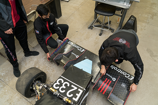 Two students working on the racecar