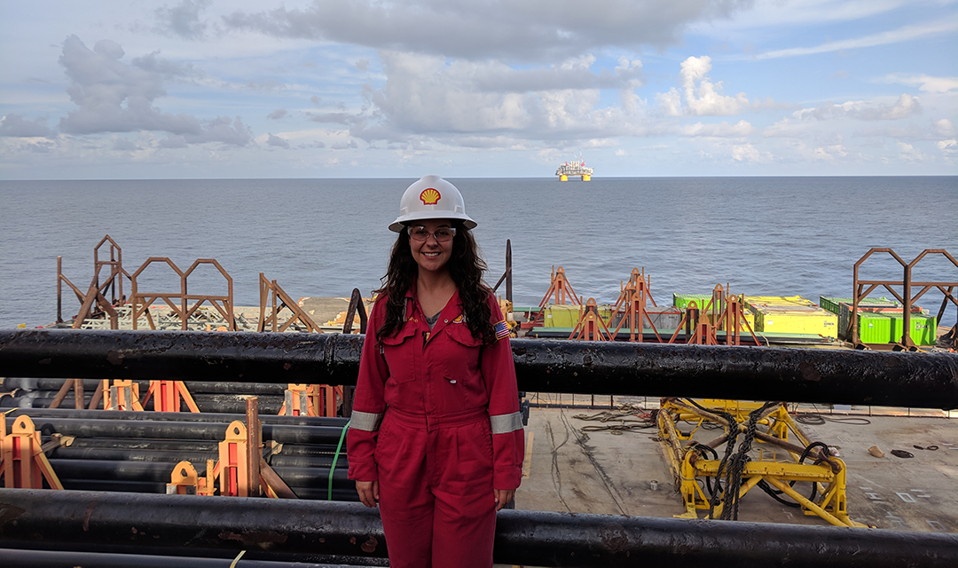 Lauren Gonzalez in a hardhat on a floating platform in the ocean