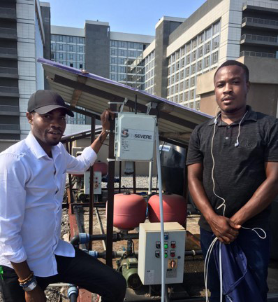 two men standing with an air quality sensor