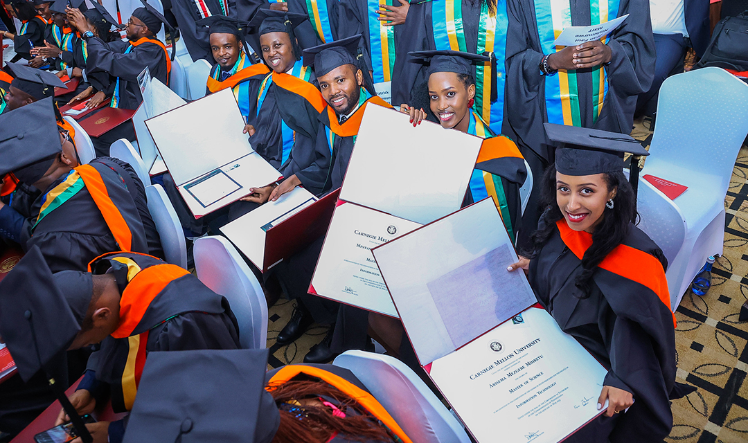 A female CMU-Africa student laughing at graduation