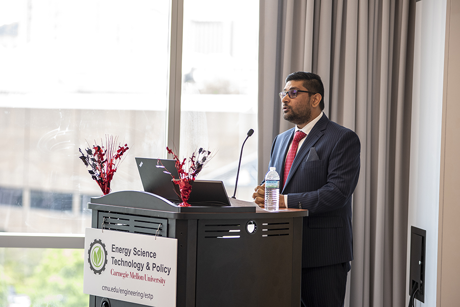 Raafe Khan speaking at a podium