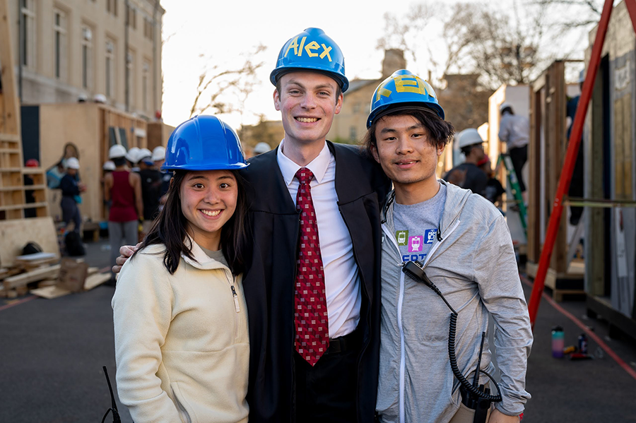 Three students wearing hardhats