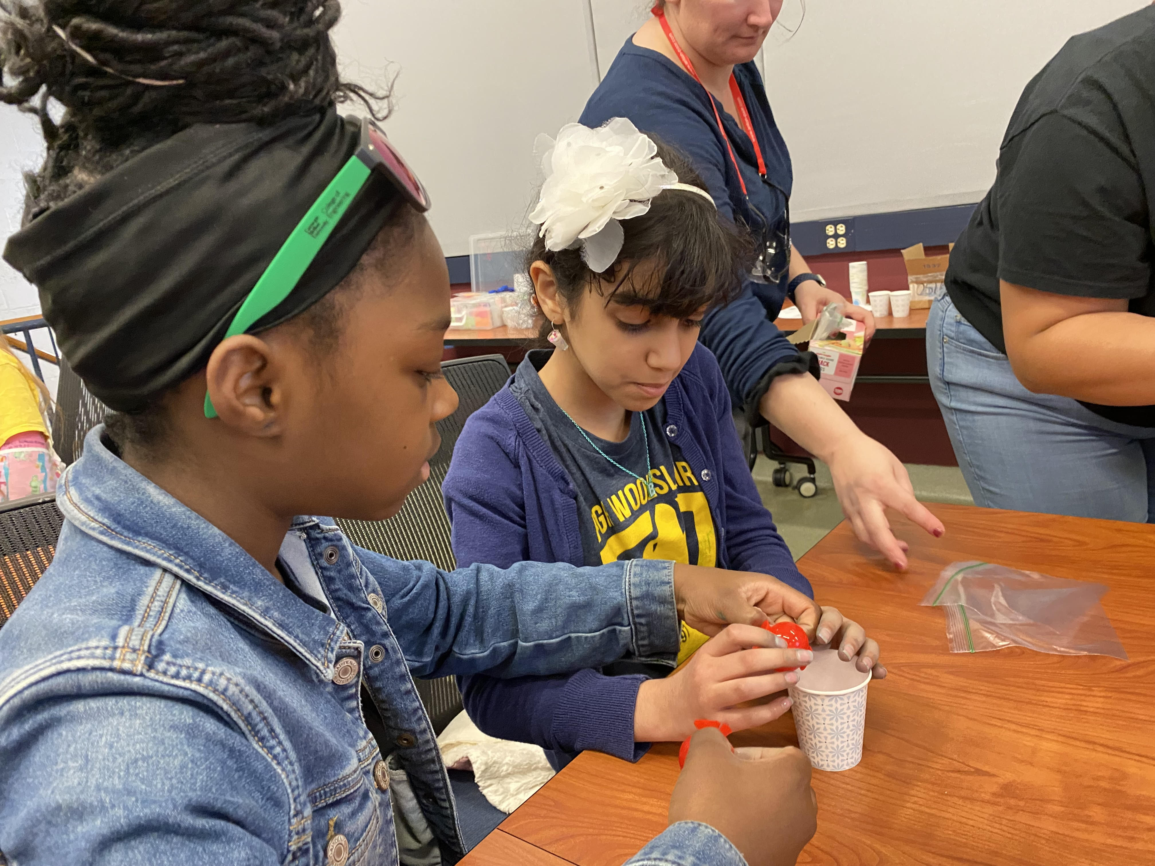 Two black elementary school girls working on a science project