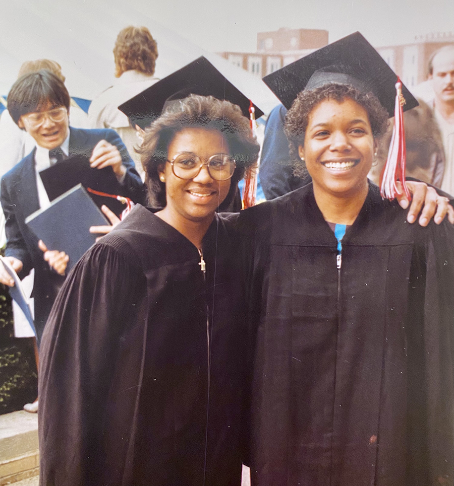 Two students in their graduation garb