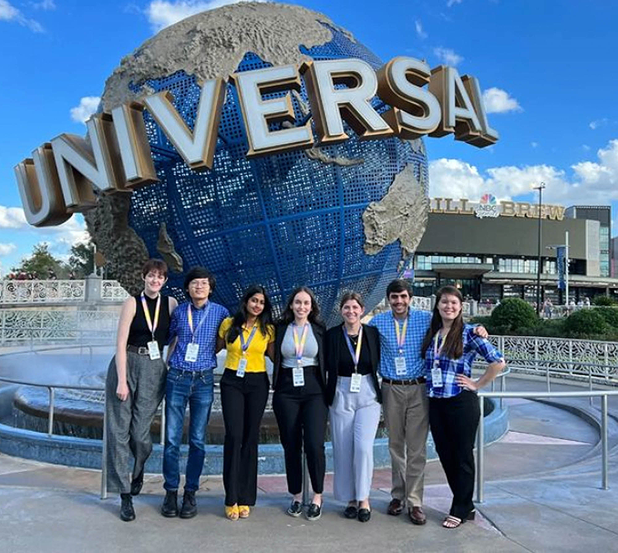 A group of students in front of the Universal globe