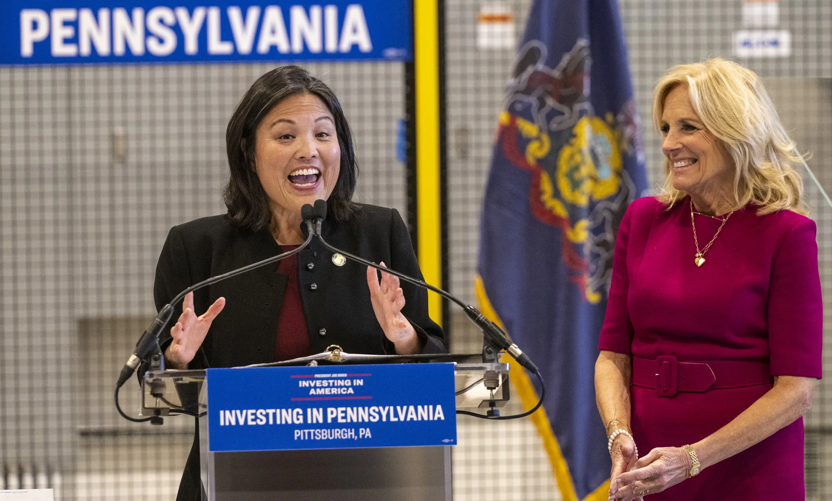 Julie Su at a podium with Jill Biden standing next to her