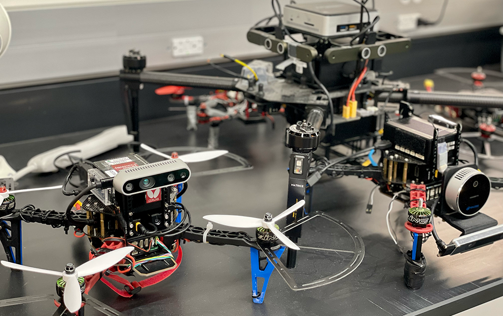 Two drones on a table with a video camera