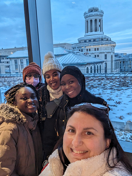 Five young woman posing with a wintry Hamerschlag Hall in the background