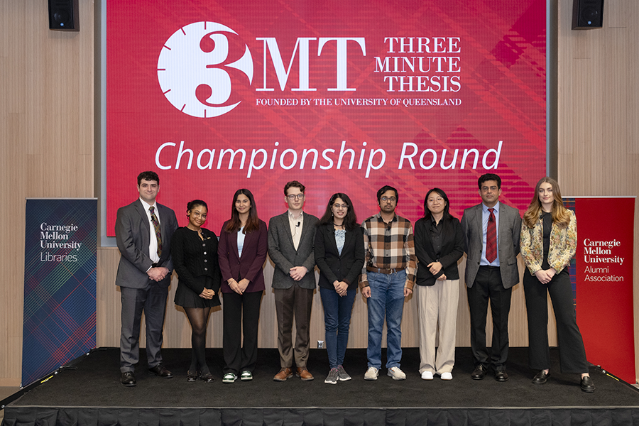 The 3MT student winners standing on a stage
