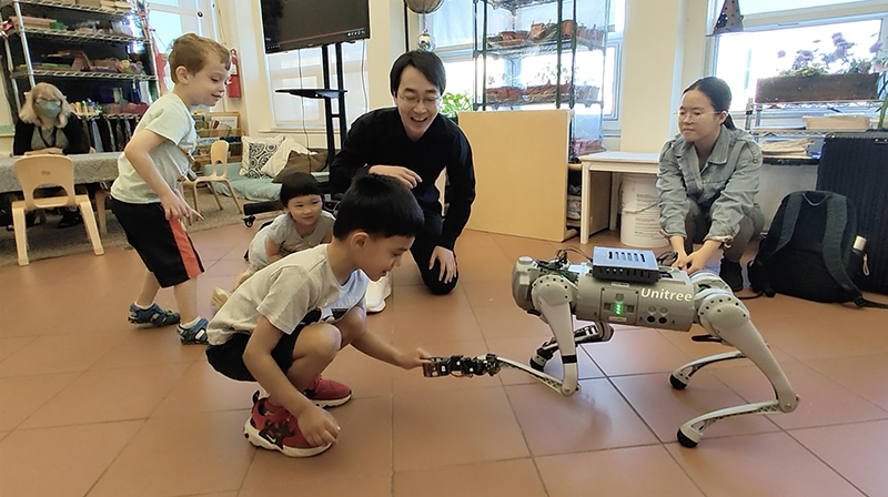 Adults and children interact with the home-helper robot