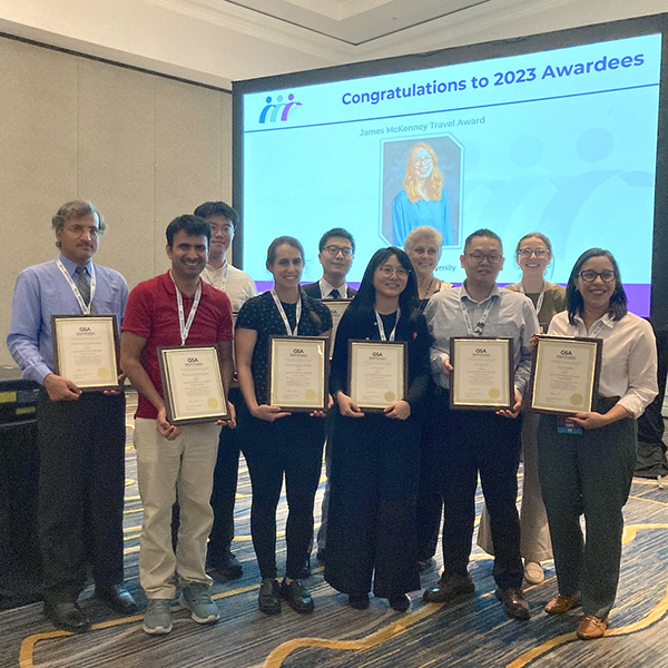 Ten students holding awards