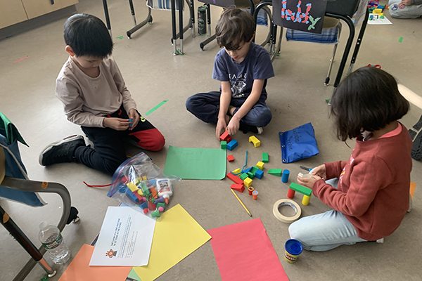 Children sit on the floor and play