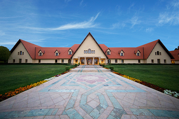 A building with a multicolor stone walkway leading up to it