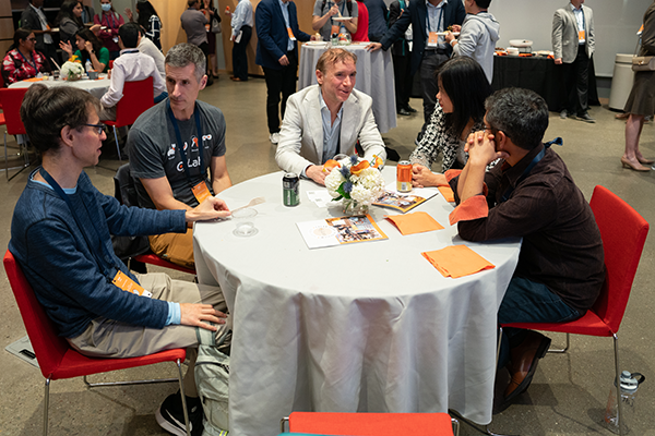 A group of people at the event chatting around a table