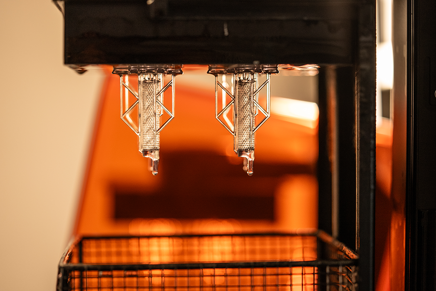 Bioelectronic implant hanging from a metal arm in the lab