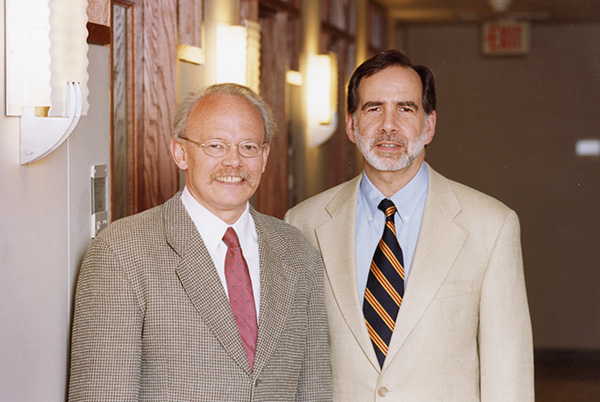 Two men in suits in an academic building